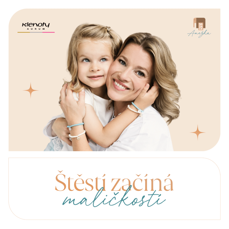 Žena objímá dívku, obě se usmívají do kamery